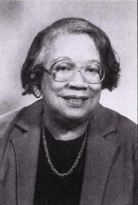 Black and white photo of woman wearing a black shirt an dark blazer